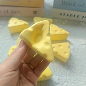 Mini Cheese Squishy being squeezed and slowly rising